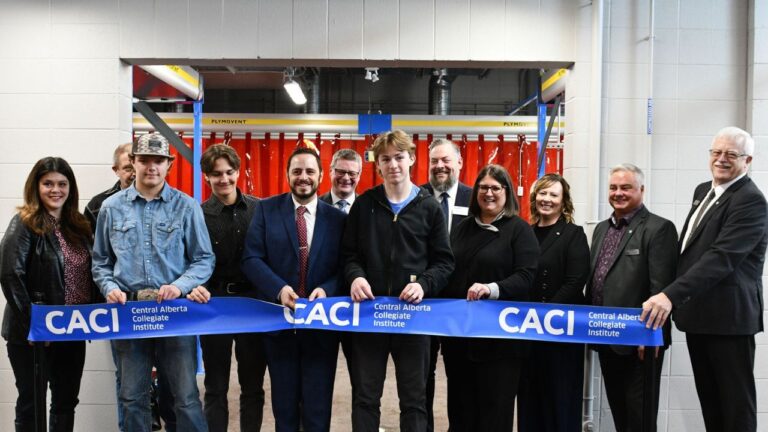 Demetrios Nicolaides, Alberta's Education Minister, and other stakeholders gather for a ribbon-cutting at the renovated Metals Building at Olds College of Agriculture & Technology on April 2, 2025. (Supplied, Olds College)