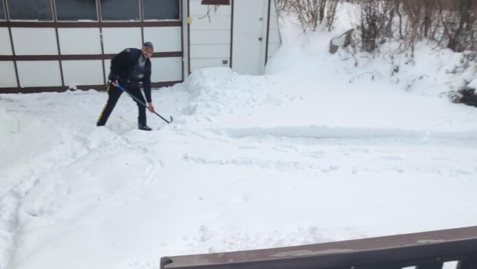 Police officer shovelling snow in Spruce Grove. (Supplied, Parkland RCMP Detachment)