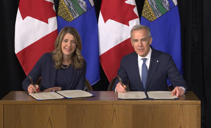 Alberta Premier Danielle Smith and Canada PM Mark Carney sign an MOU in Calgary on May 15, 2026. (Your Alberta, Youtube)