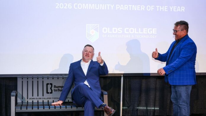 Rob Rhodes with Bumper to Bumper (on bench) and Todd Ormann with Olds College at the 2026 Strive and Thrive event. (Supplied, Olds College of Agriculture and Technology)