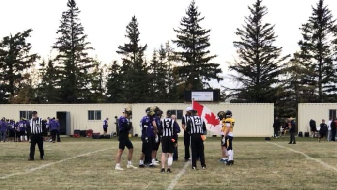 The Ecole Olds High School Spartans hit the field wearing special purple jerseys for the coin toss ahead of a charity football game to raise awareness about domestic violence and gather donations for Kirsten's Place on September 25, 2026. (mymountainviewnow.com staff)